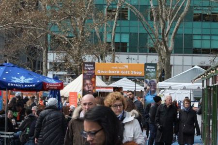 A crowd bustles in front of World Vision's interactive pop-up shop in New York City's Bryant Park on Tuesday November 29, 2017.