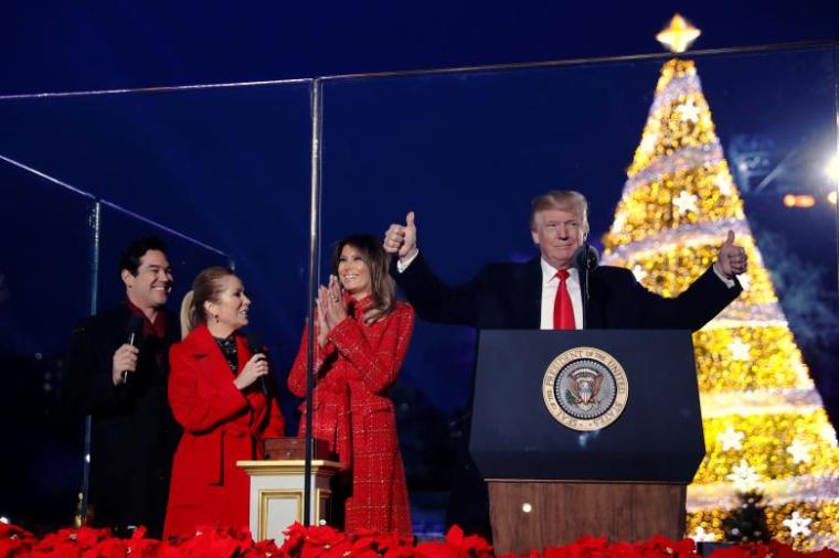 First lady Melania Trump, with President Donald Trump and hosts Dean Cain (L) and Kathie Lee Gifford (2nd L), reacts after she pressed the button to light the tree in Washington, D.C. November 30, 2017.