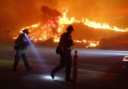 Ventura County firefighters battle the Solimar brush fire that started early Saturday morning in Ventura County, California December 26, 2015.