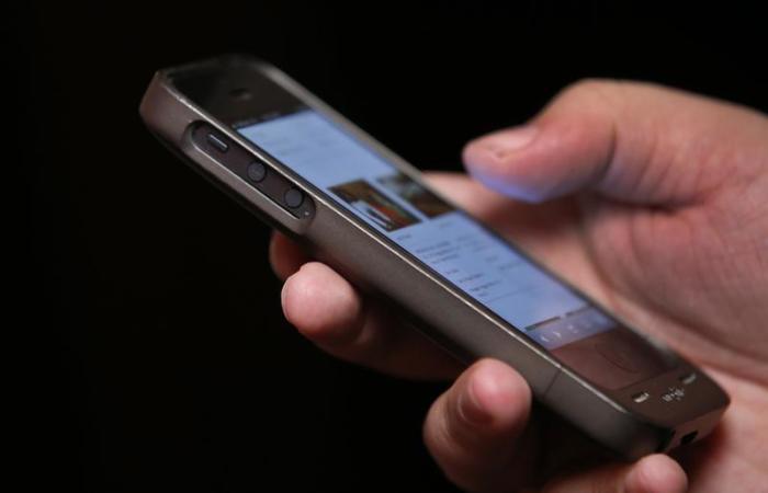 A man uses a smartphone in New York City, in this picture taken November 6, 2013.