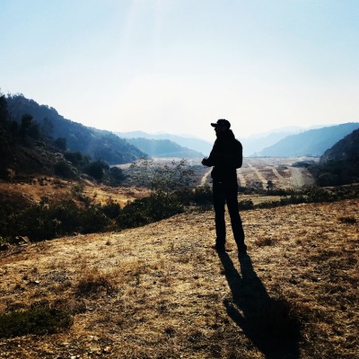 Bel-Air Presbyterian Church pastor Drew Sams surveys property adjacent to his church one mile from the Skirball fire in Bel-Air, California on December 6, 2017.