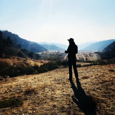 Credit : Bel-Air Presbyterian Church pastor Drew Sams surveys property adjacent to his church one mile from the Skirball fire in Bel-Air, California on December 6, 2017.