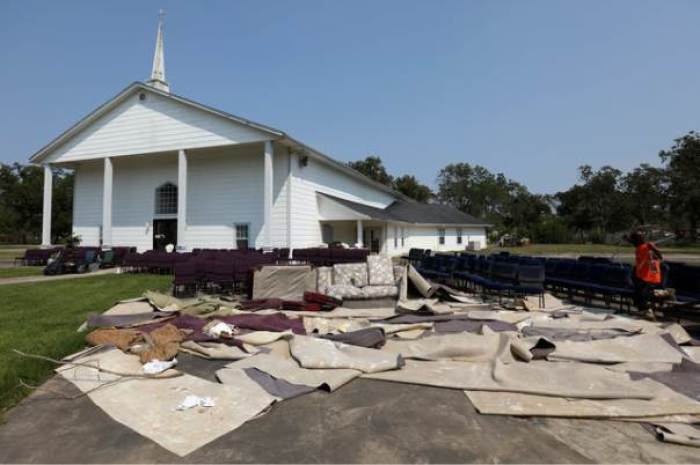 Carpets, chairs and assorted items are removed from the New Faith Church in the aftermath of flooding from tropical storm Harvey in Wharton, Texas, U.S., September 6, 2017.