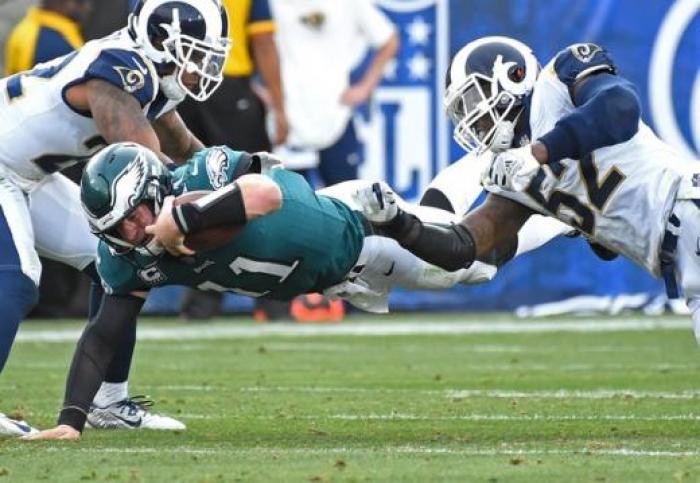 Philadelphia Eagles quarterback Carson Wentz (11) is stopped by Los Angeles Rams at Los Angeles Memorial Coliseum on December 10, 2017.