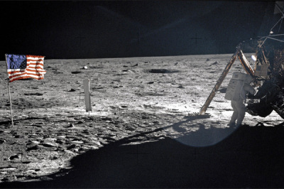 Apollo 11 Commander Neil Armstrong working at an equipment storage area on the lunar module.