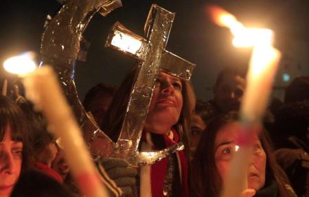 Egyptian Muslims and Christians celebrate Coptic Christmas eve mass, at Tahrir Square in Cairo, January 6, 2013.