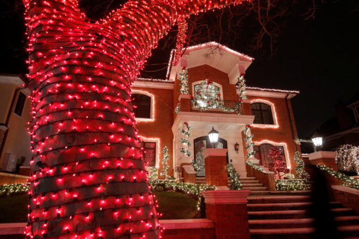 People gather outside a house decorated during the Dyker Heights Christmas Lights in the Dyker Heights neighborhood of Brooklyn, New York City, U.S., December 23, 2016.