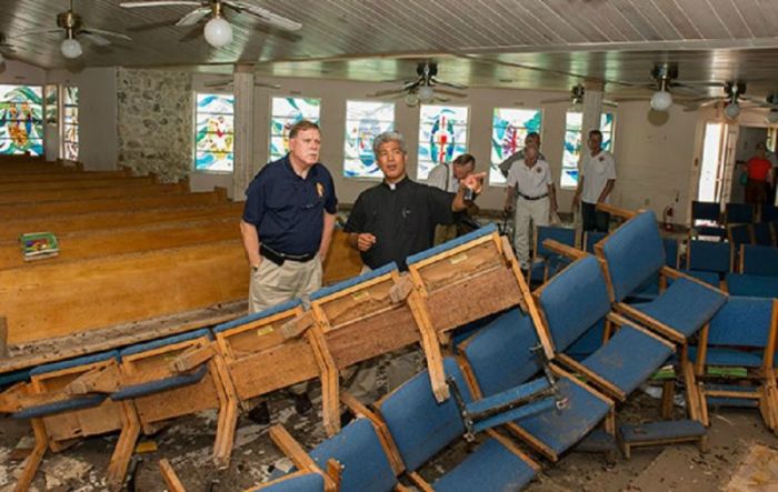 Father Jesus Medina (R) talks with Knights of Columbus Vice Supreme Master Dennis Stoddard (L) inside the sanctuary of St. Peter Catholic Church in Big Pine Key, Florida.