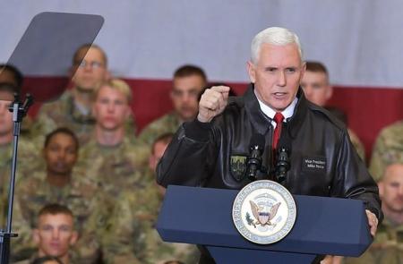 U.S. Vice President Mike Pence arrives on stage to address troops in a hangar at Bagram Air Field in Afghanistan on December 21, 2017.