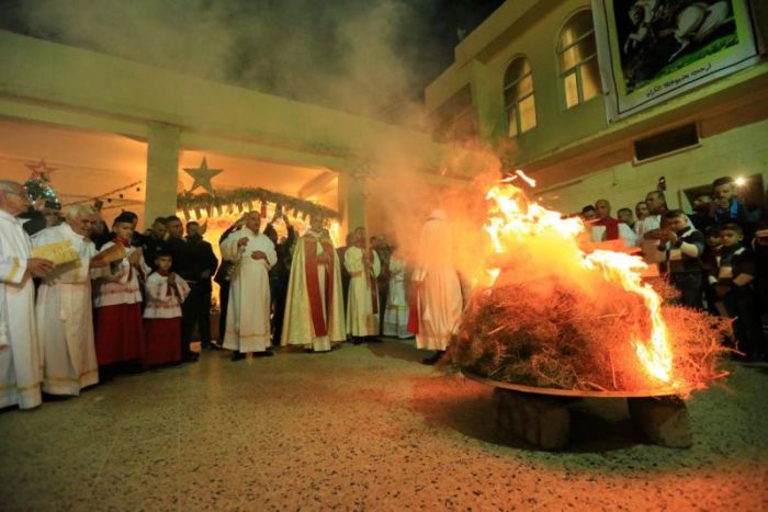 Iraqi Christians pray during a mass on Christmas Eve at Church of Saint George in Teleskof, Iraq, December 24, 2017.