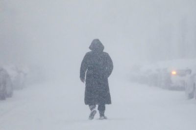 A woman walks down the street during a blizzard in Long Beach, New York in this undated photo.