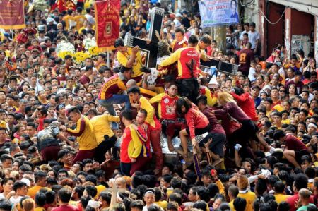 Devotees jostle one another as they try to touch the Black Nazarene replica during an annual procession in Quiapo, Manila, Philippines, on January 7, 2018.