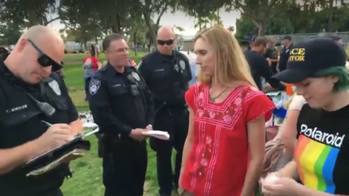 Shane (L) and Ever (R) Parmely are written up by police officers in El Cajon, California for feeding the homeless on Jan. 14, 2018.