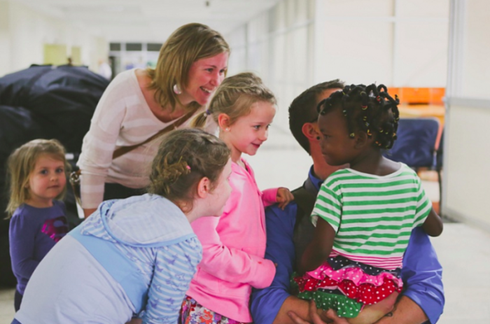 The Via family unites with their adopted daughter and sister, Chloe, for the first time in this photo from April 2012.