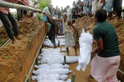 Rohingya refugees, who died after their boat capsized as they were fleeing from Myanmar, are buried in a mass grave just behind Inani beach near Cox's Bazar, Bangladesh September 29, 2017.