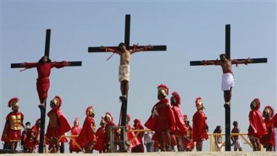 Penitents hang on crosses as they are crucified during Good Friday Lenten rites in Cutud, San Fernando Pampanga in northern Philippines April 22, 2011.