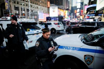 New York Police Department (NYPD) officers walk in Times Square ahead of New Year's Eve celebrations in Manhattan, New York, U.S. December 30, 2017.