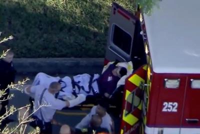 A man who was placed in handcuffs by police is loaded into a paramedic vehicle after a shooting incident at Marjory Stoneman Douglas High School in Parkland, Florida, February 14, 2018, in a still image from video.