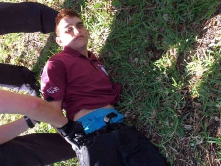 Nikolas Cruz is placed into handcuffs by police near Marjory Stoneman Douglas High School following a mass shooting in Parkland, Fla., Feb. 14, 2018.