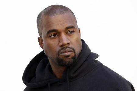 American rapper Kanye West poses before French fashion house Christian Dior Autumn/Winter 2015/2016 women's ready-to-wear collection show during Paris Fashion Week March 6, 2015.