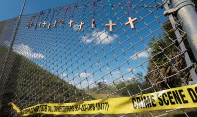 Crosses hanged at a fence near Marjory Stoneman Douglas High School in Parkland, Florida for the victims who lost their lives