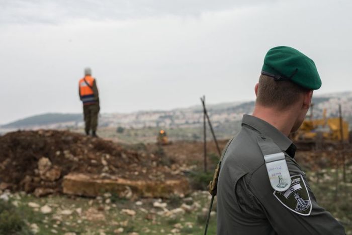 Border police officer securing the location of road paving to Netiv HaAvot neighborhood in Elazar, Gush Etzion, as part of the preparations for the upcoming demolition. February 12, 2018.