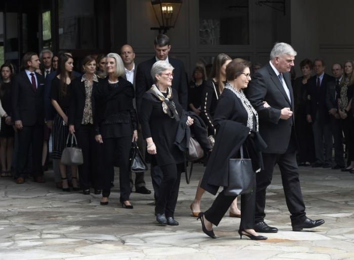 Family members, including Franklin Graham (R) and Anne Graham Lotz (center) walk to vehicles before the body of Rev. Billy Graham leaves the Billy Graham Training Center at the Cove on Saturday, Feb. 24, 2018, in Asheville, N.C.