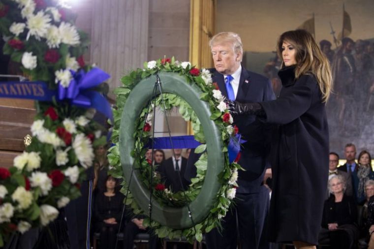 Donald and Melania Trump lay a wreath as Billy Graham lies in honor at the U.S. Capitol, Feb. 28, 2018.