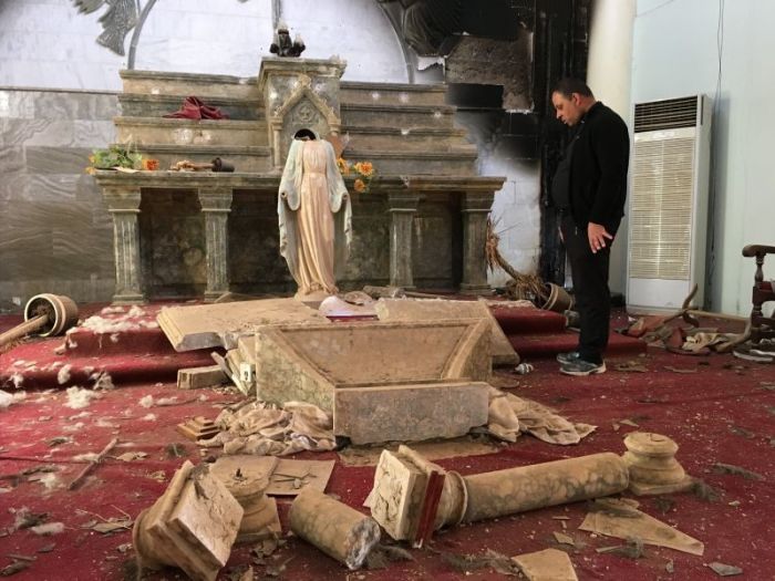 Father Thabet Habib evaluates the inside of a burned out church right in Karamles, Iraq right after the town's liberation from the Islamic State in October 2016.