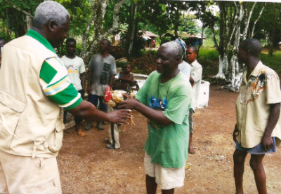 Pastor James Cuffee of Christ Evangelistic Fellowship Ministries in Liberia recieves gifts from villagers in this undated photo.