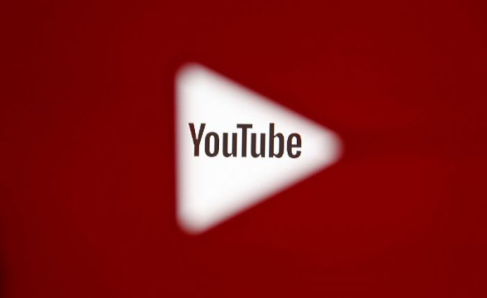 A 3D-printed YouTube icon is seen in front of a displayed YouTube logo in this illustration taken October 25, 2017.