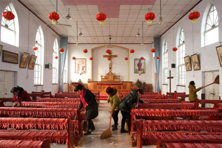 Members of the congregation clean the unofficial catholic church after Sunday service in Majhuang village, Hebei Province, China.