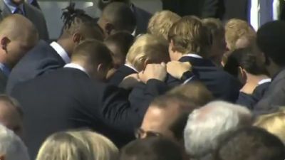 Players on the University of Alabama championships football team pray with President Donald Trump at the White House on April 10, 2018.