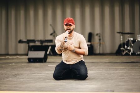 Luis Javier Ruiz praying for the LGBT Coomunity on his knees at the Freedom March in Washington D.C., May 5, 2018