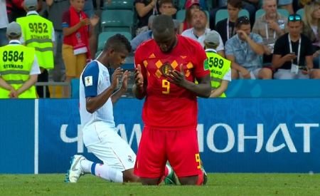 Romelu Lukaku of Belgium (R) and Fidel Escobar of Panama kneeling in prayer following a 2018 World Cup match in Russia on June 18, 2018.