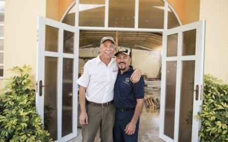 Tom Ovington, Samaritan's Purse ministry program manager for Puerto Rico, and Pastor Roberto Vega Santiago embrace in front of Iglesia Cristiana Carismática Monte De Sión in Adjuntas, Puerto Rico.