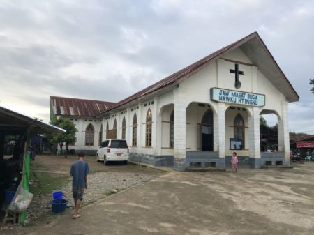 People walk outside of a church in the Kachin state of Myanmar, where 95 percent of residents are Christian.