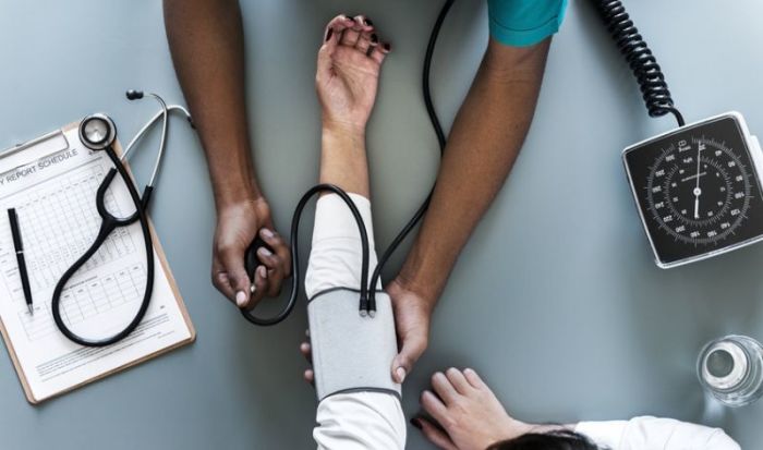 A person is shown having their blood pressure taken.