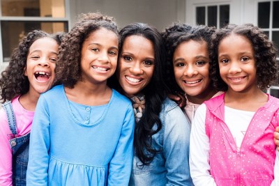 Wynter Pitts (center), founder of For Girls Like You magazine, poses with her four daughters.