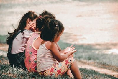 Three children sitting together in this photo uploaded on May 28, 2018.