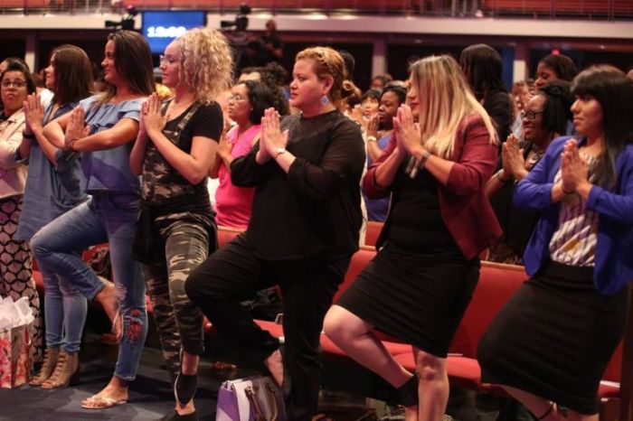 Women at Potter's House Dallas engage in yoga exercises on Saturday August 4, 2018.