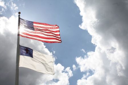 A Christian flag flies below the flag of the United States.