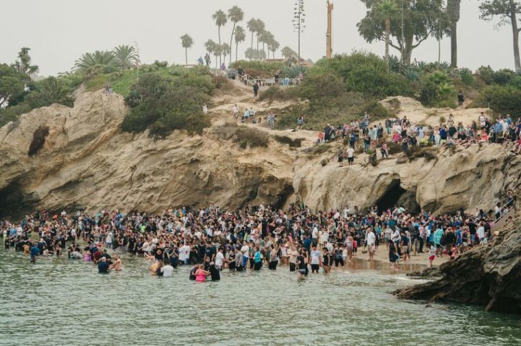 Hundreds gather to be baptized at Pirates Cove Beach in Newport Beach, California on Sept. 8, 2018. The mass baptism was organized by Greg Laurie's Harvest Christian Fellowship.