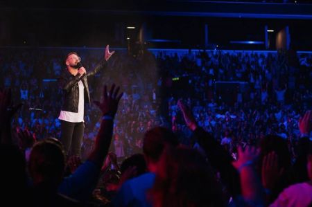 Former lead pastor of Hillsong Church, New York City, Carl Lentz worships at the Barclays Center in Brooklyn, New York.