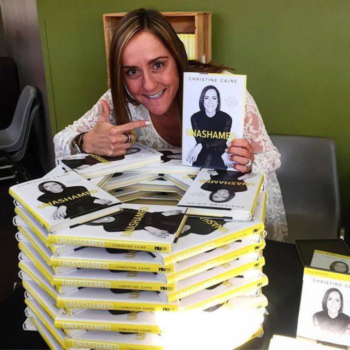 International evangelist and author Christine Caine, poses with copies of her 2016 book, Unashamed.