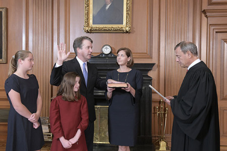 Chief Justice John G. Roberts, Jr., administers the Constitutional Oath to Judge Brett M. Kavanaugh in the Justices' Conference Room, Supreme Court Building. Mrs. Ashley Kavanaugh holds the Bible.