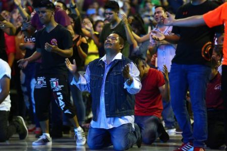 An attendee kneels in worship during the Billy Graham Evangelistic Association's Festival de Esperanza in Monterrey, Mexico in October 2018.