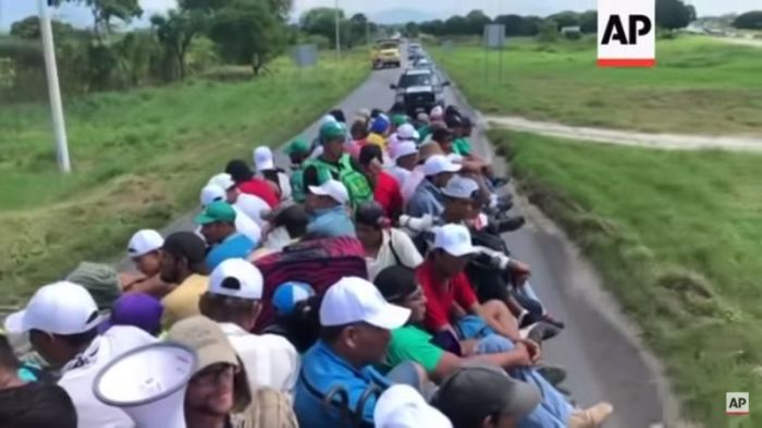 Thousands of migrants set out before dawn on October 24, 2018 from the far-southern Mexico city of Huixtla toward the U.S.