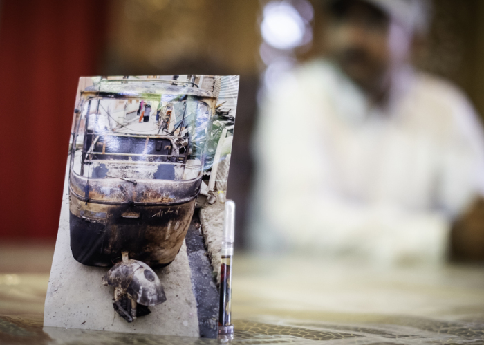 Abel, a Christian taxi driver from Srinagar, displays a photo of his taxi that was destroyed by a group of Muslims after his faith was made public. He must now rent taxis, which limits his income to provide for is family.