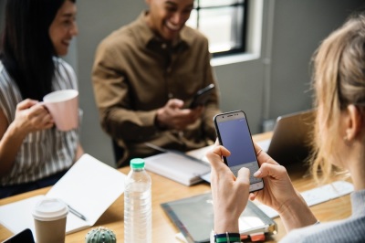 Three people engage in a workplace meeting. 